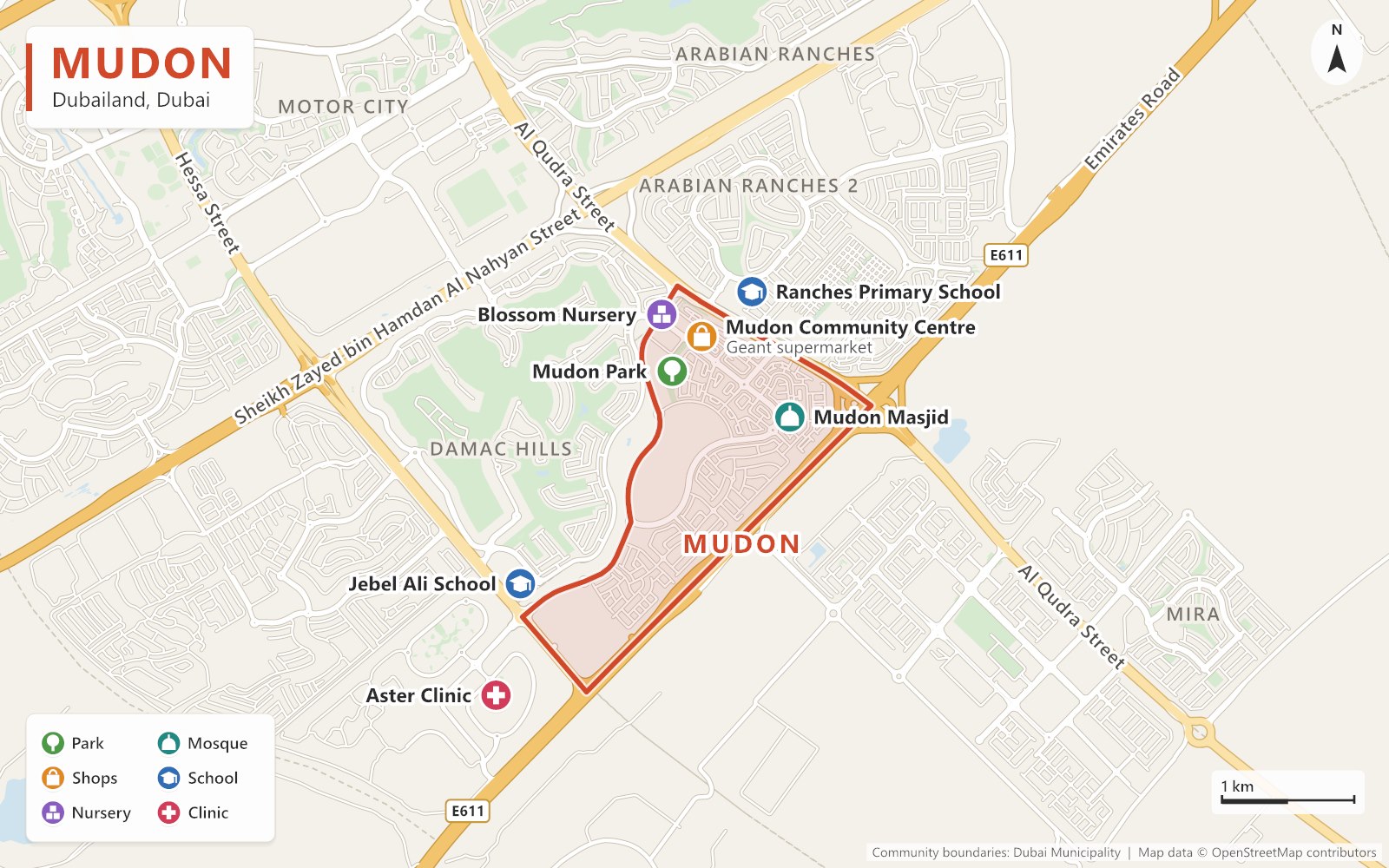 Close-up map of Mudon outlined in red between Al Qudra Street and Emirates Road, next to Damac Hills and Arabian Ranches 2, with Mudon Park, Mudon Community Centre, Blossom Nursery, Mudon Masjid, nearby schools and a clinic marked.