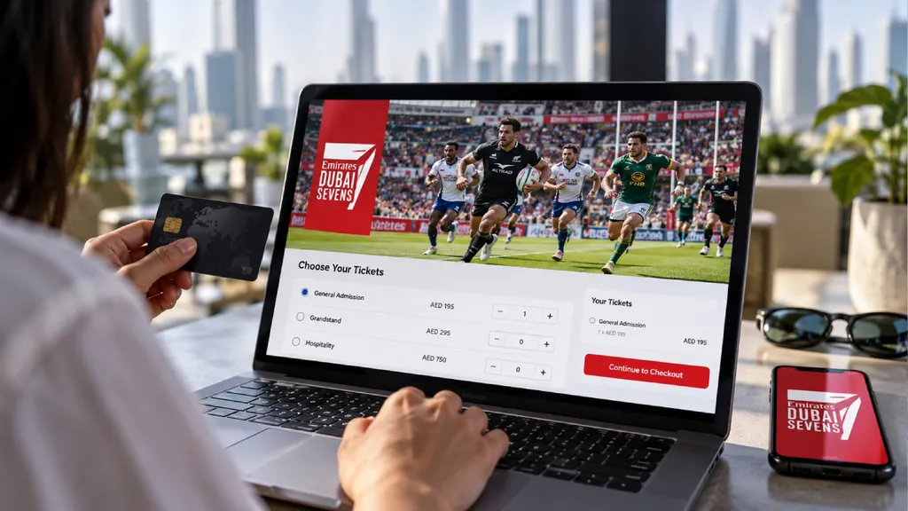A person purchases Dubai Sevens rugby tickets on a laptop, selecting ticket options and proceeding to checkout while holding a credit card, with Emirates Dubai Sevens branding visible on the laptop and smartphone screens